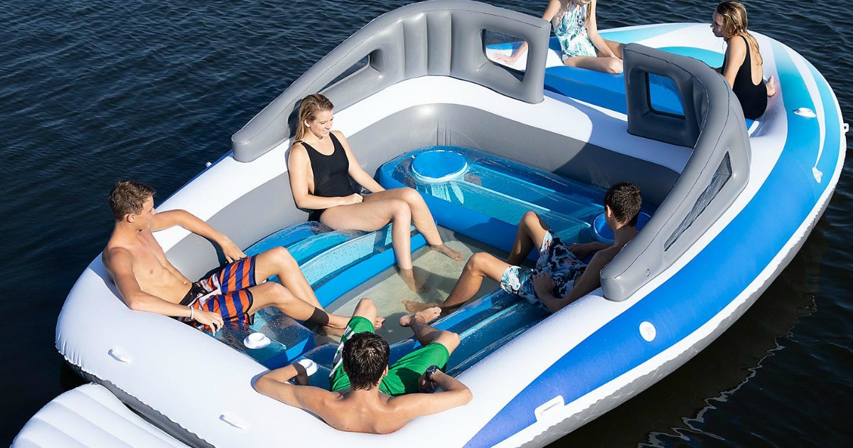 people sitting on inflatable boat in water