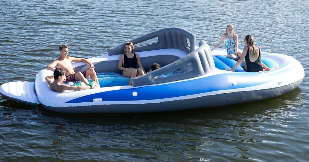 people sitting on inflatable boat in water