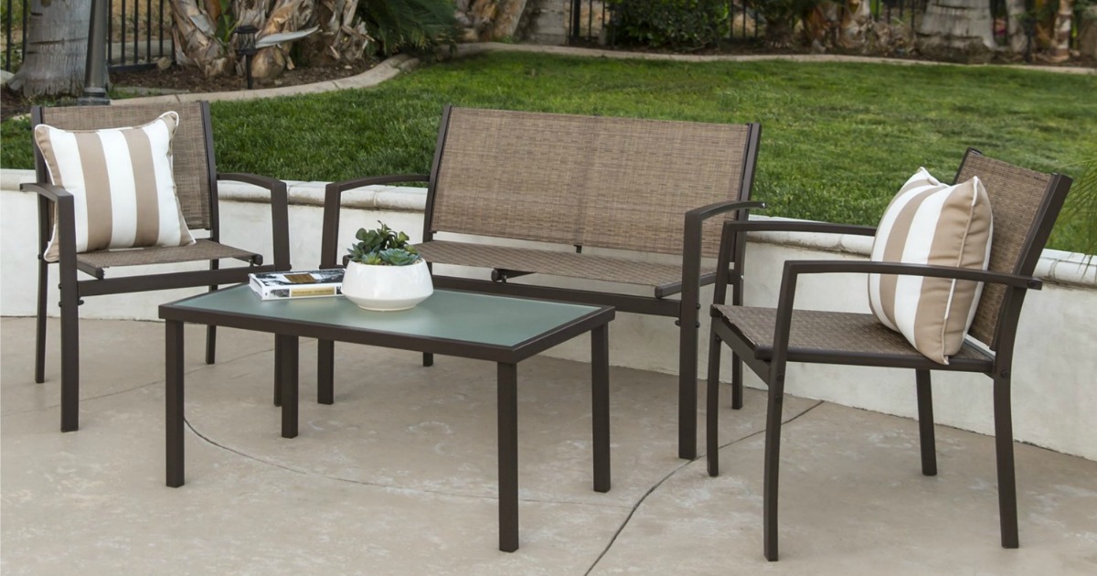 patio set including two chairs with pillows, glass-top table and loveseat placed outside