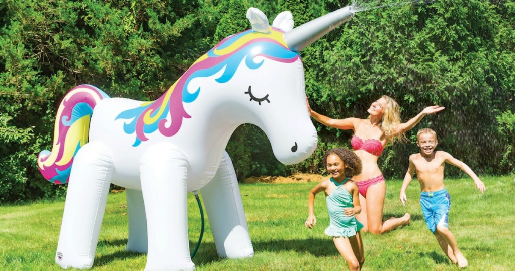 Mom and two kids playing with a HUGE unicorn inflatable yard sprinkler