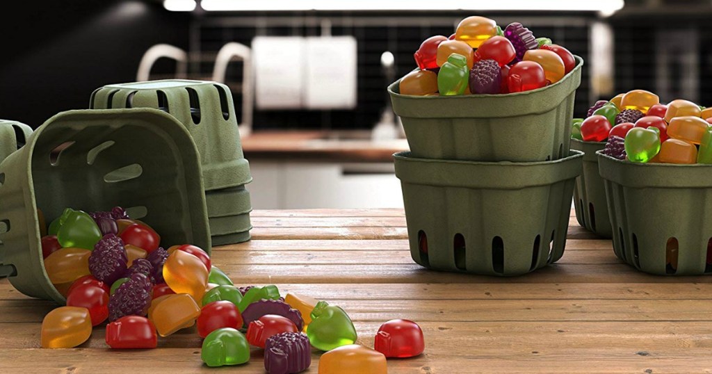 fruit containers filled with fruit shaped snacks on wood table