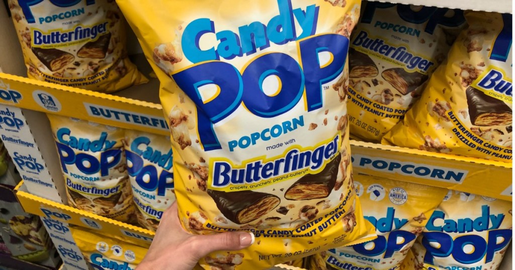 Woman holding Candy Pop Butterfinger Popcorn at Sam's Club