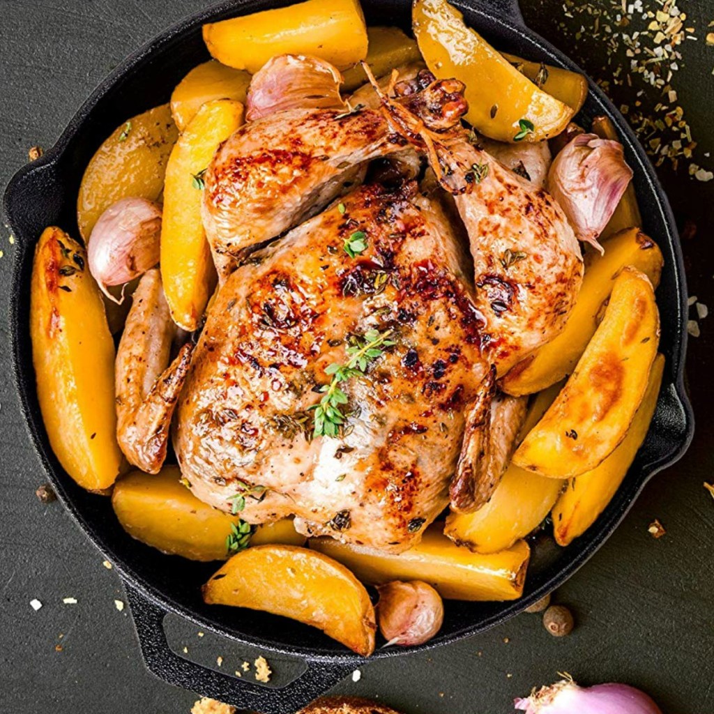Cast iron skillet with whole chicken dish