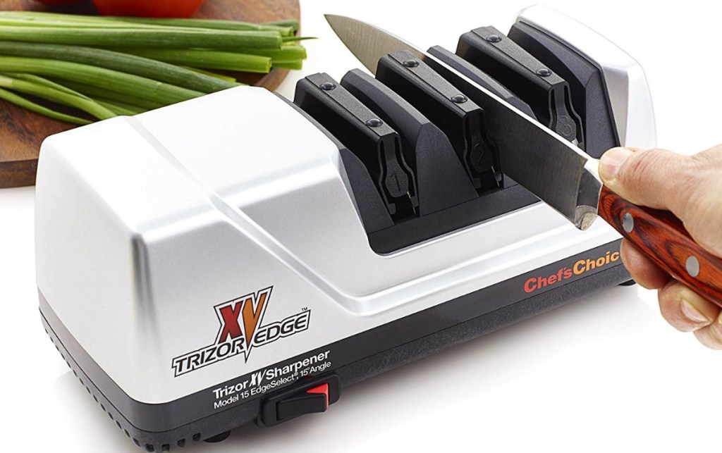 hand holding knife in Chef's Choice knife sharpening machine