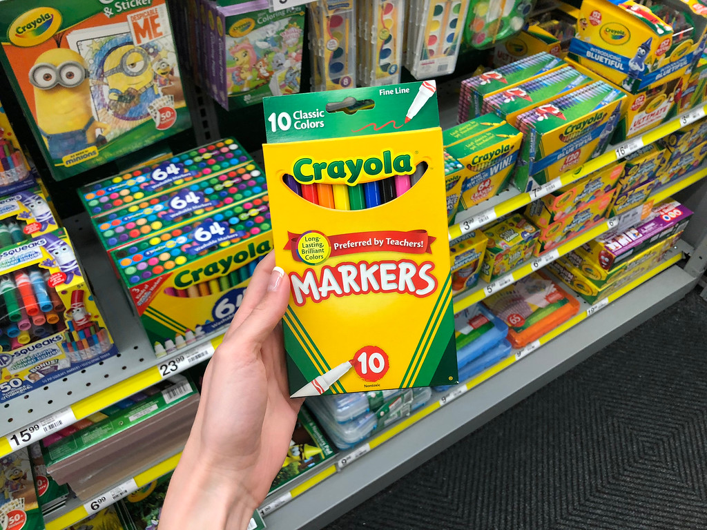 Crayola Markers being held by a woman's hand