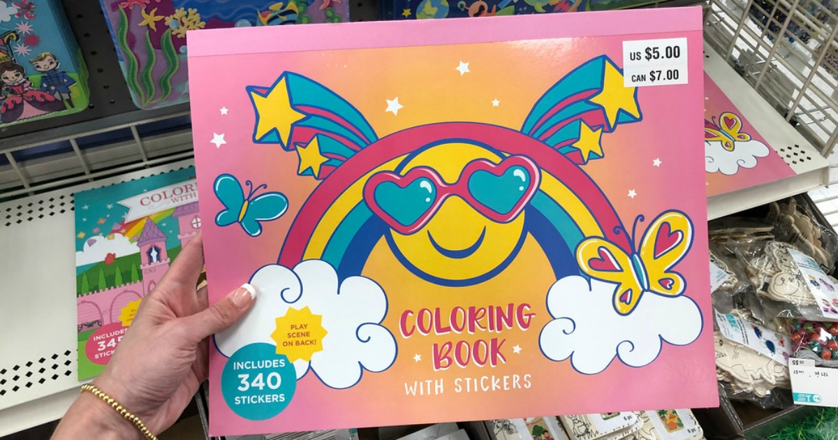 person holding a Creatology coloring book with stickers at Michaels
