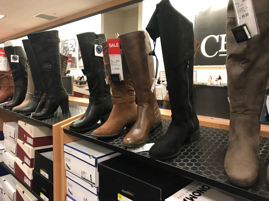 women's riding boots lined up on shelf