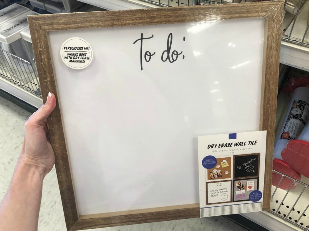 hand holding big square dry erase board in store