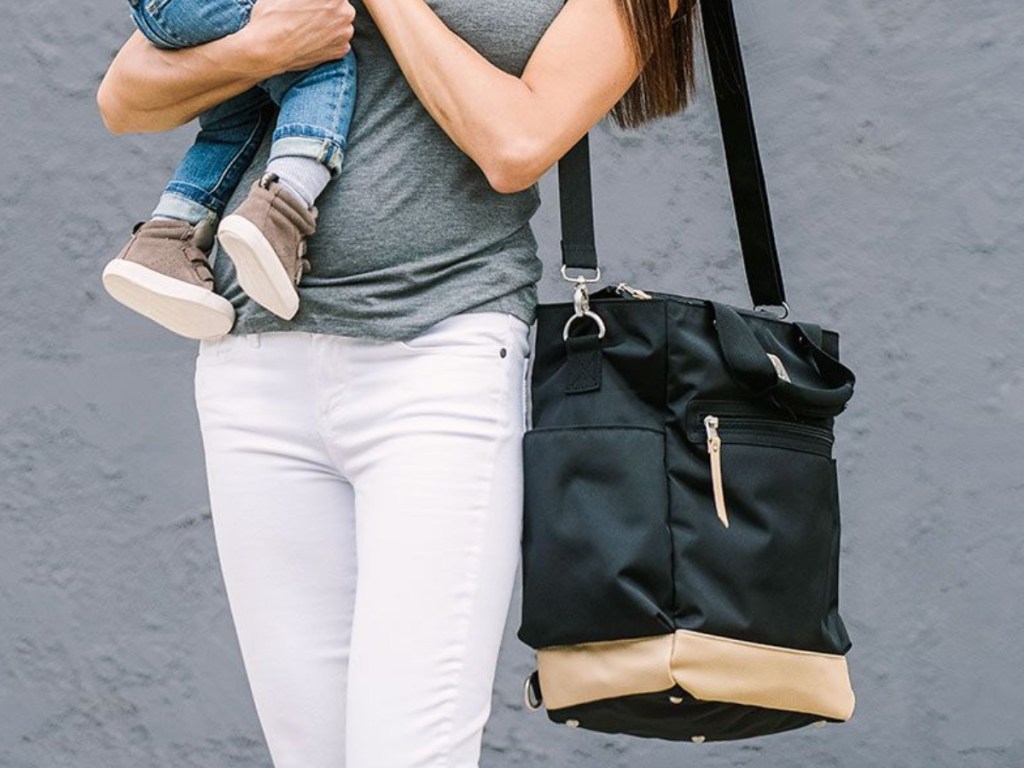Ergobaby Black & Tan Coffee Run Tote mom holding bag and baby