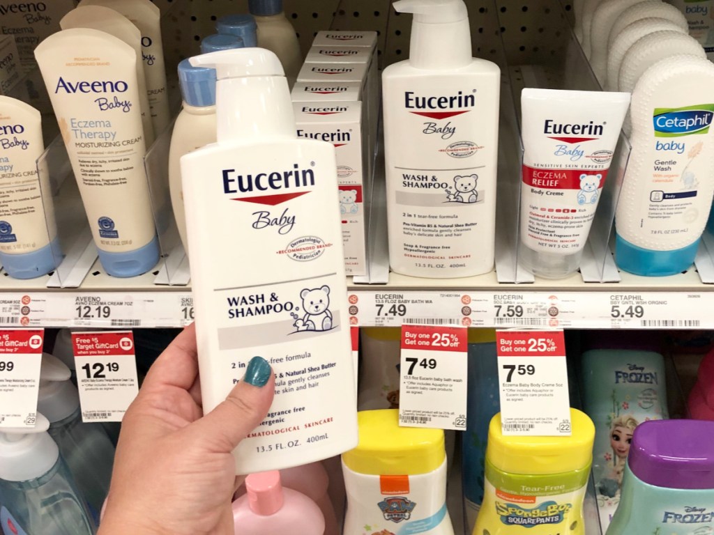 Hand holding Eucerin Baby Wash and Shampoo at Target
