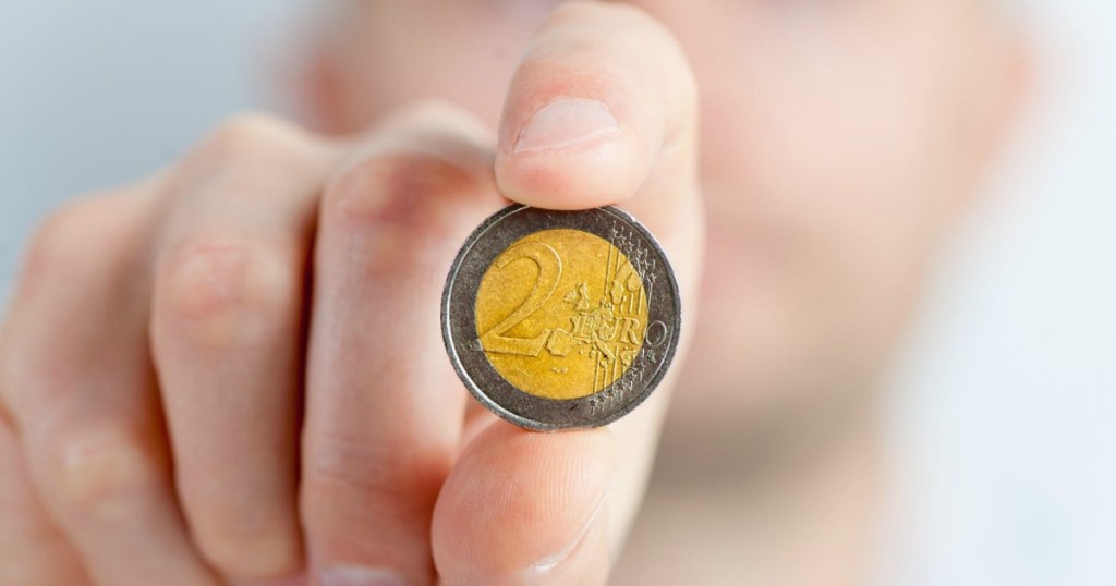 Person Holding 2 Euro Coin