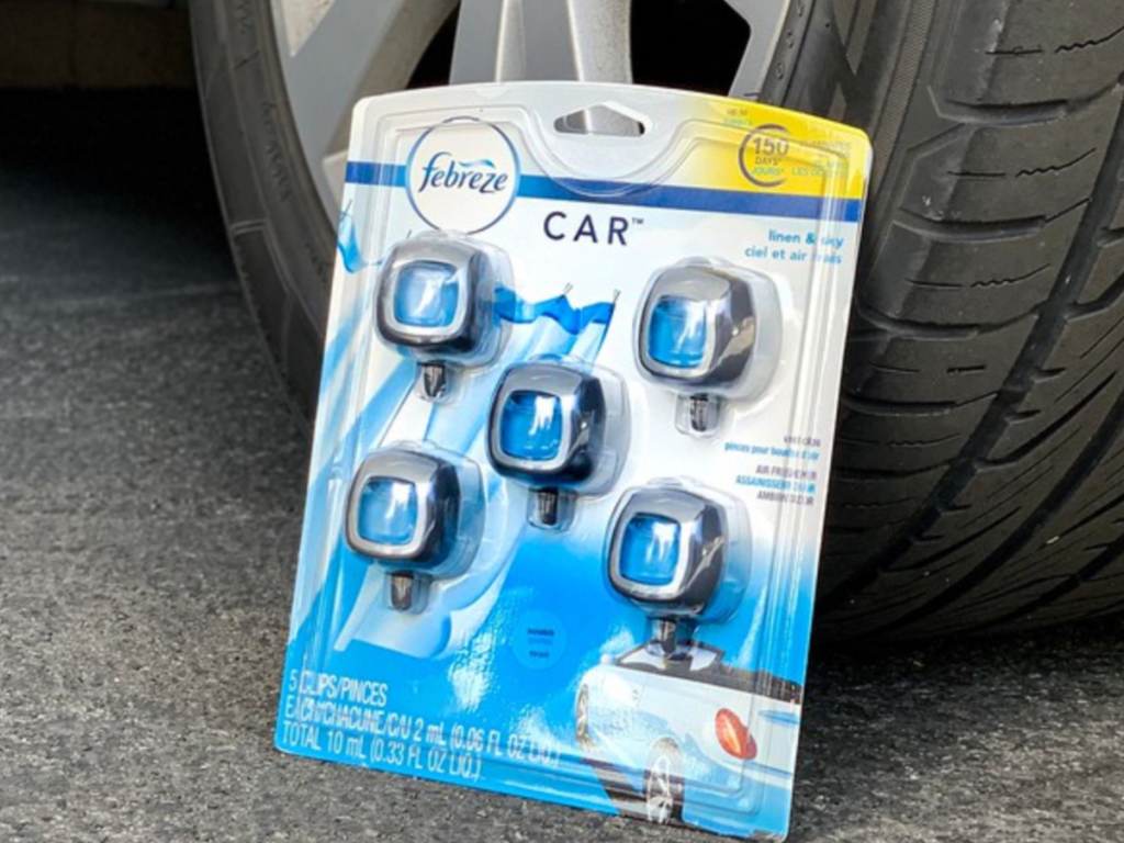 Febreze Car Air Freshener 5 pack leaned on car tire