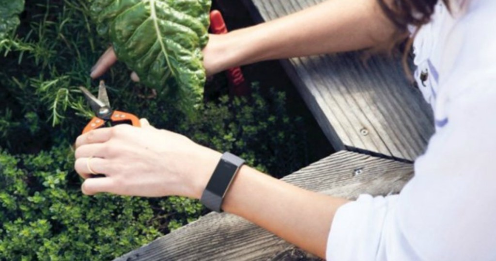 woman wearing a fitness tracker while doing yard work
