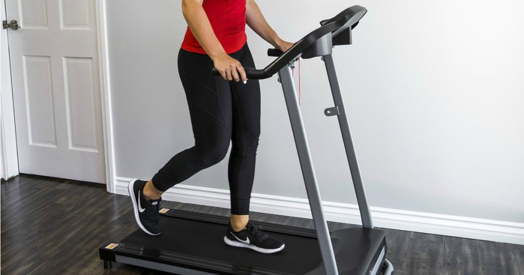 woman walking on black and silver treadmill
