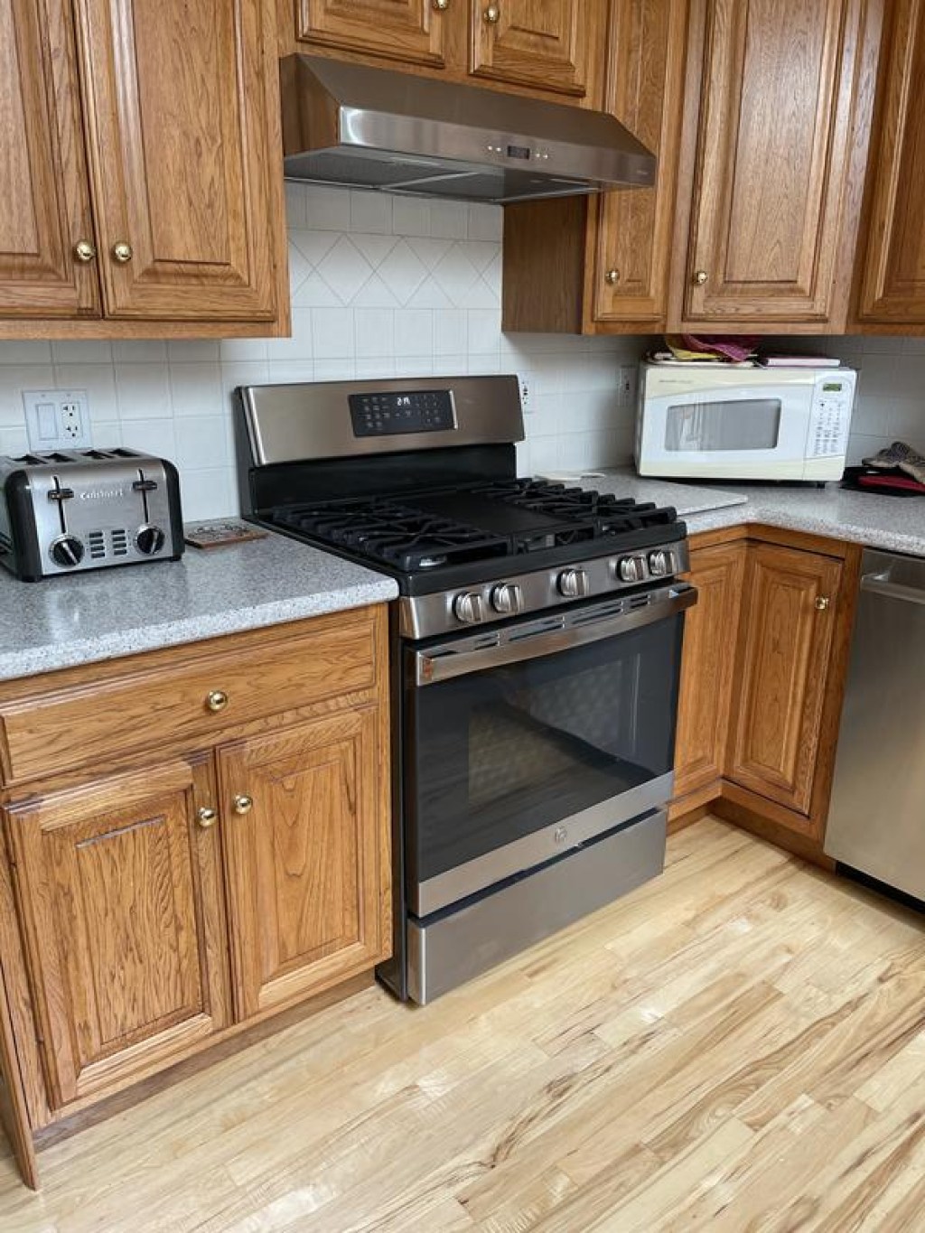 GE stainless steel stove with gas range in brown kitchen