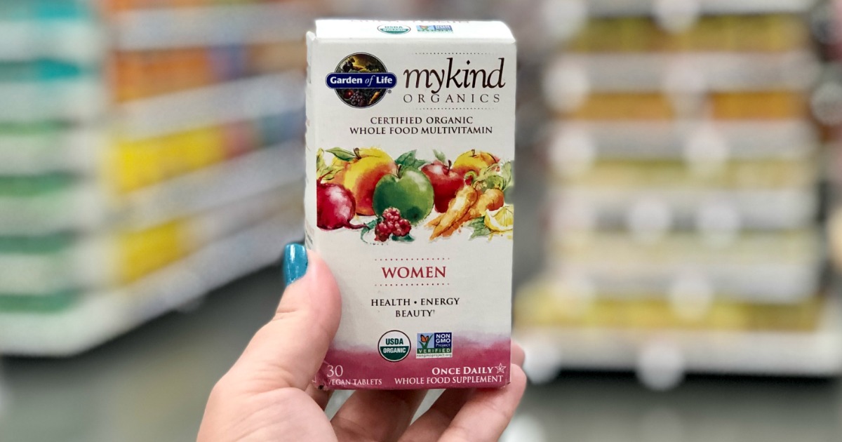 hand holding garden of life mykind womens vitamins