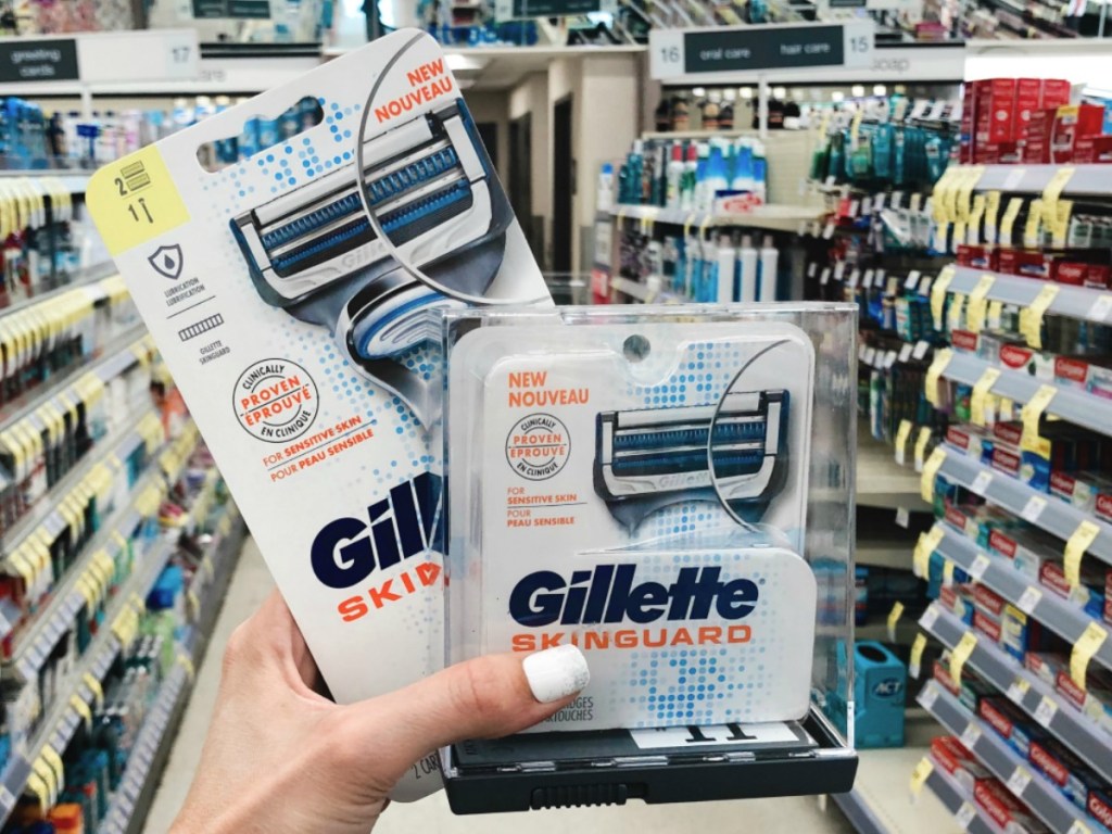 Woman holding Gillette Skinguard Razor and Refill Cartridges