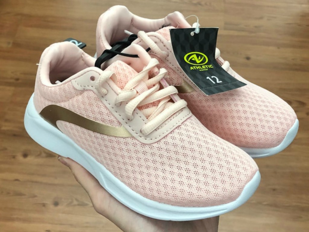 pair of light pink and gold girls shoes in store