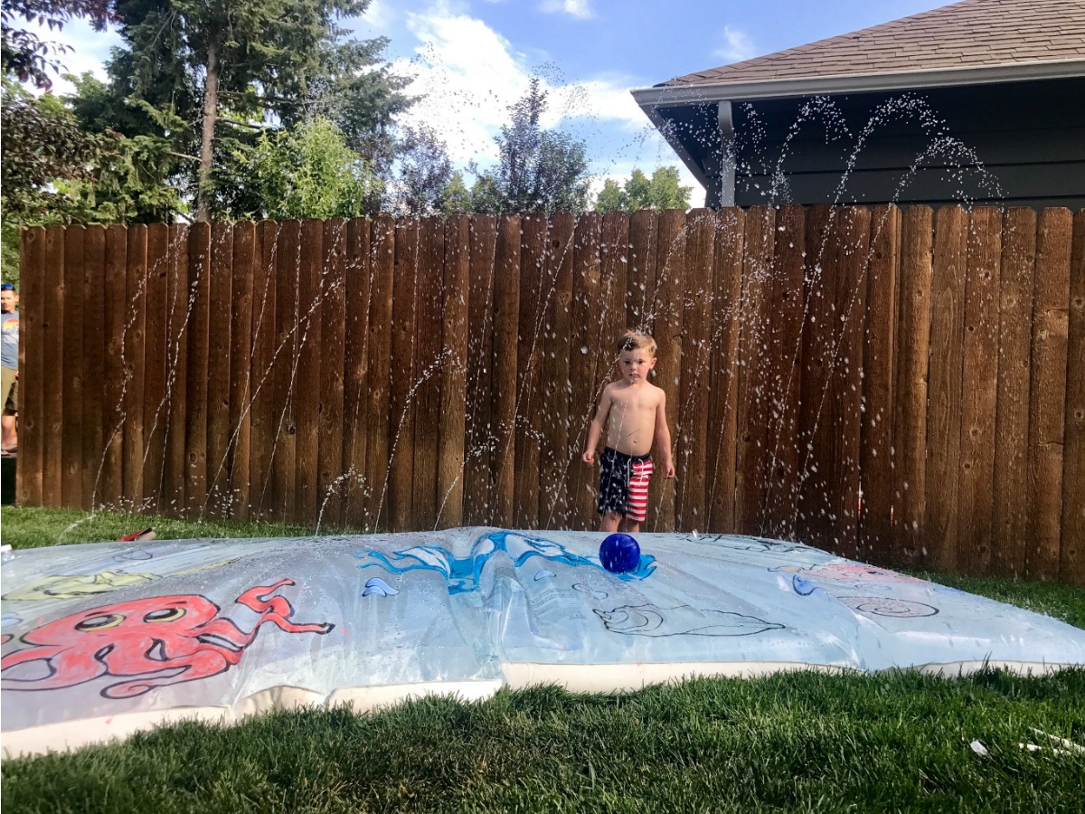 h20 water play mat sprinkling water in back yard