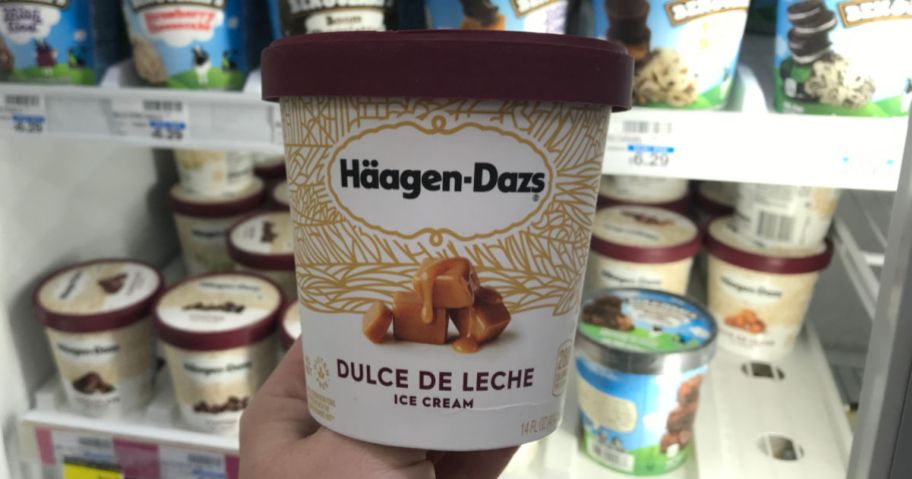 haagen dazs ice cream pint being held up by freezer