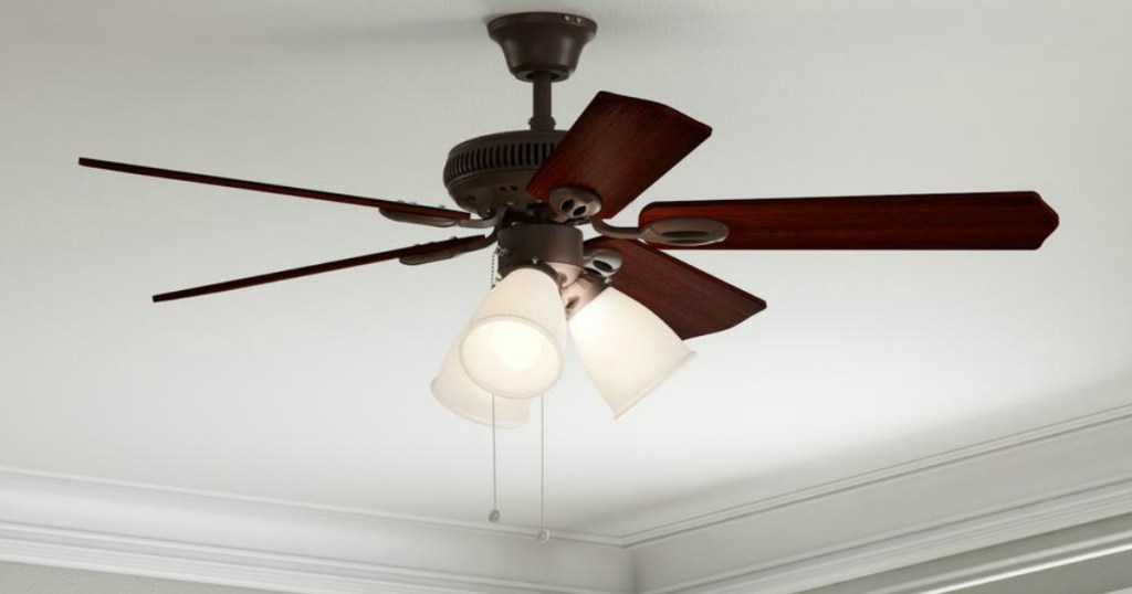 brown ceiling fan with three lights