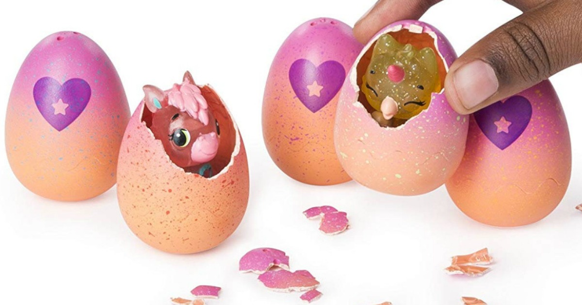 pink, orange and purple hatchimal eggs, with two eggs hatched with birds looking out