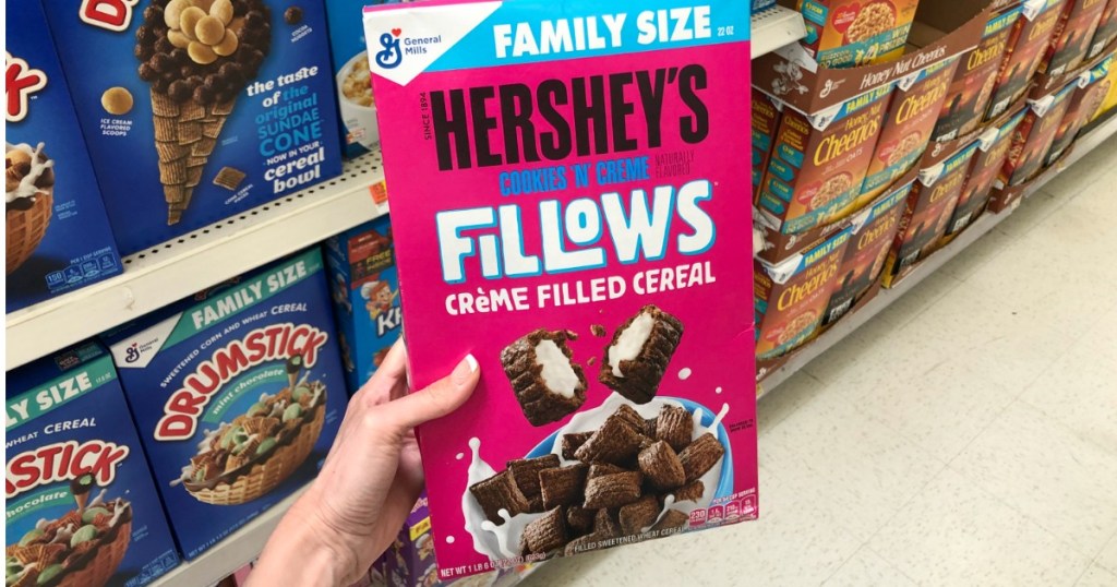 Woman holding box of Hershey's Cookies 'N' Creme Fillows