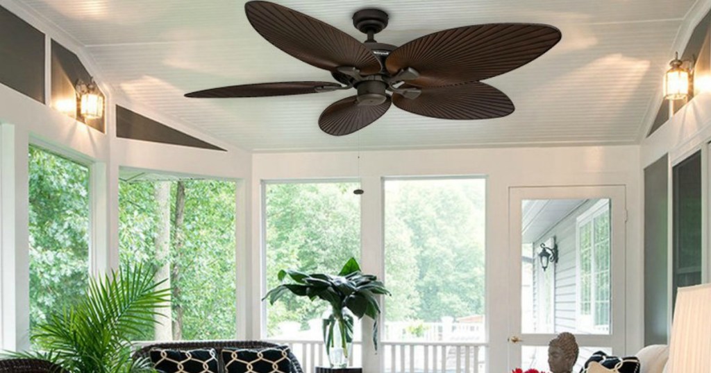 brown fan with palm blades on ceiling of porch