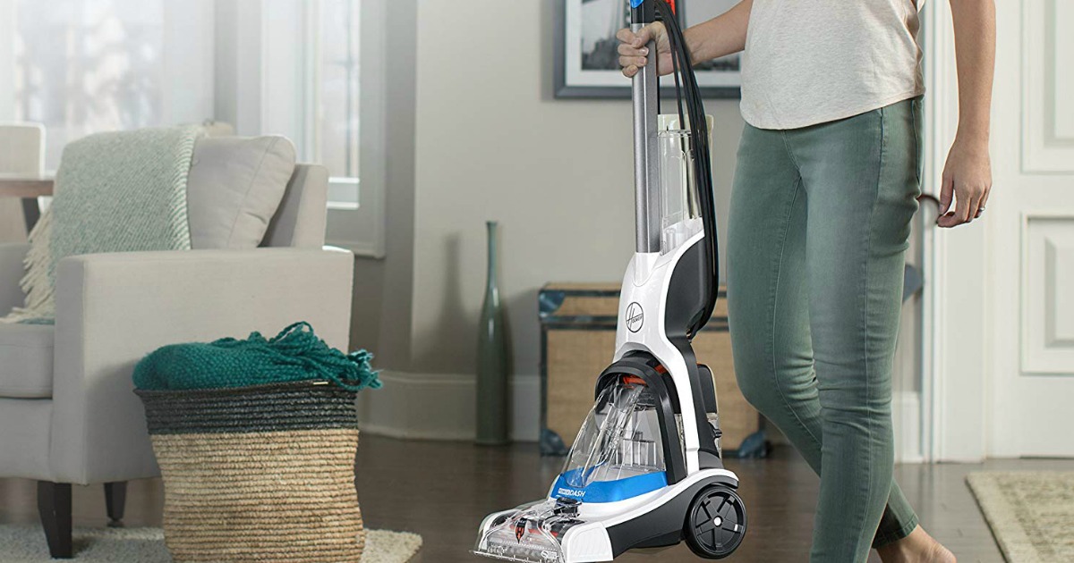 woman carrying Hoover Power Dash carpet cleaner