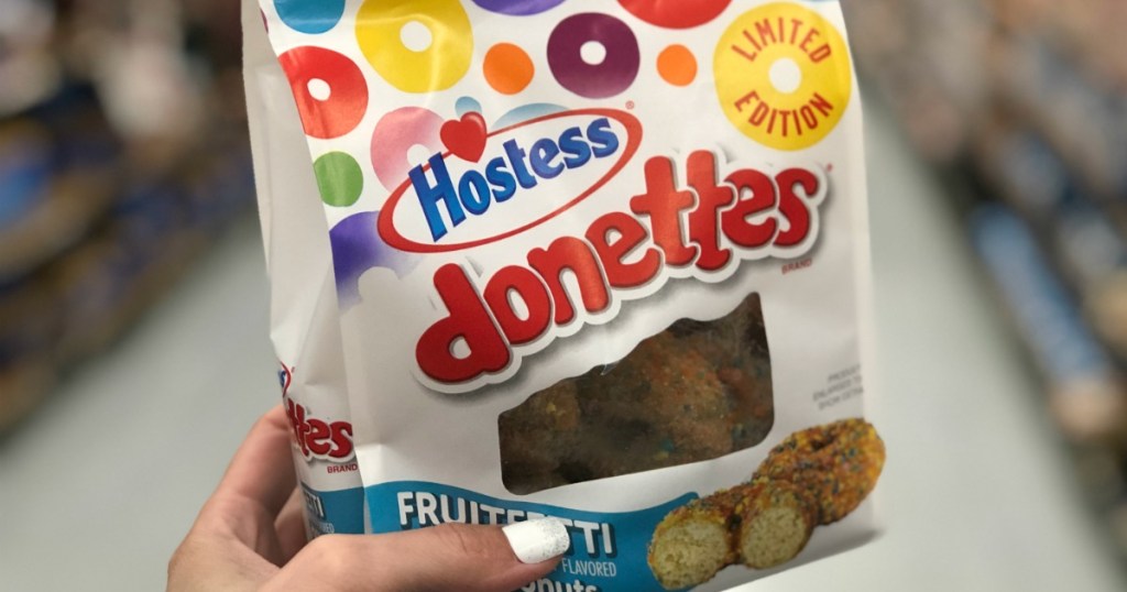 hand holding hostess donettes bag in open aisle