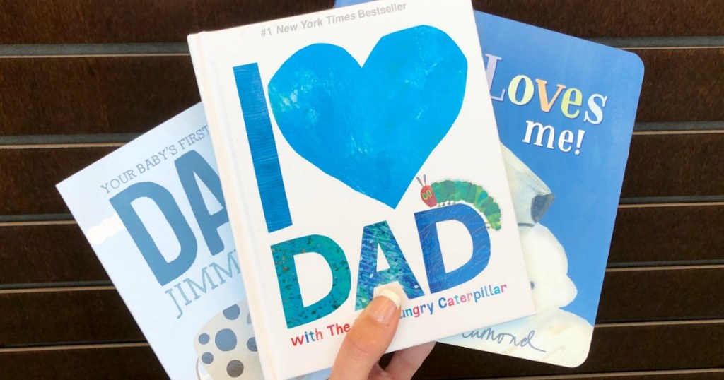 Woman holding up collection of Father's Day Books at Barnes & Noble