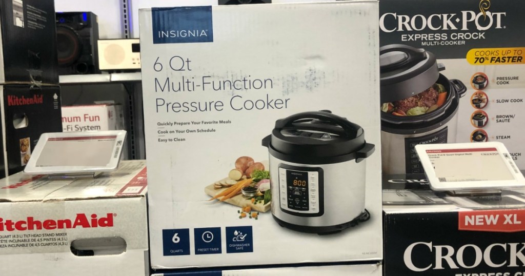 Pressure cooker sitting in the store by other small kitchen appliances