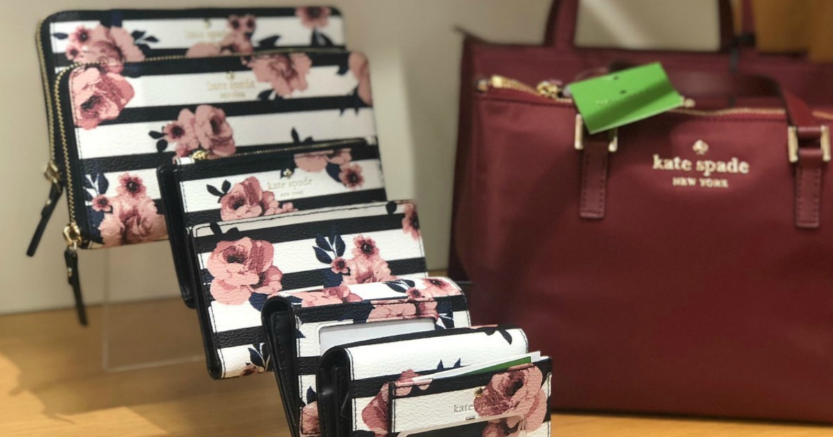 black and white stripe with rose patterned Kate Spade wallets on display