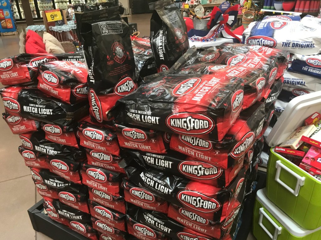 red and black kingsford charcoal bags stacked in store