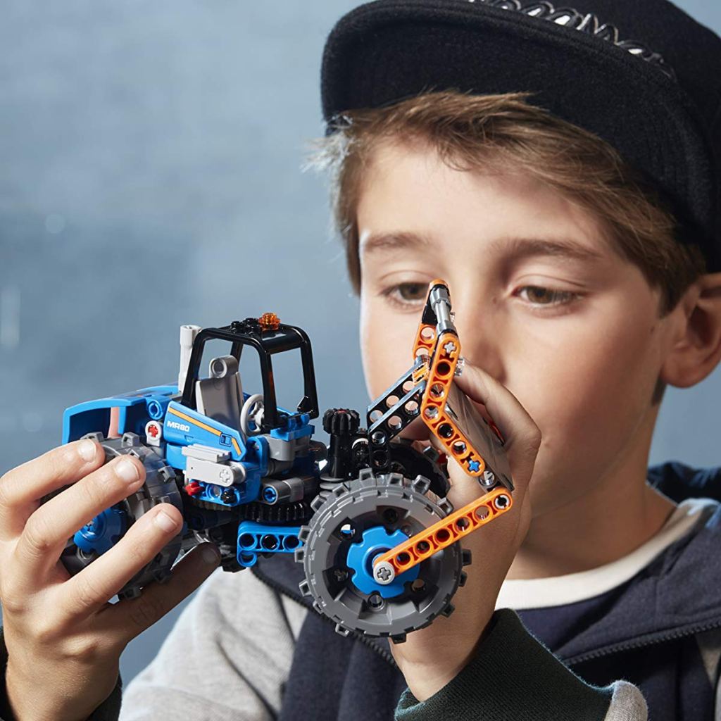 boy holding LEGO Technic set