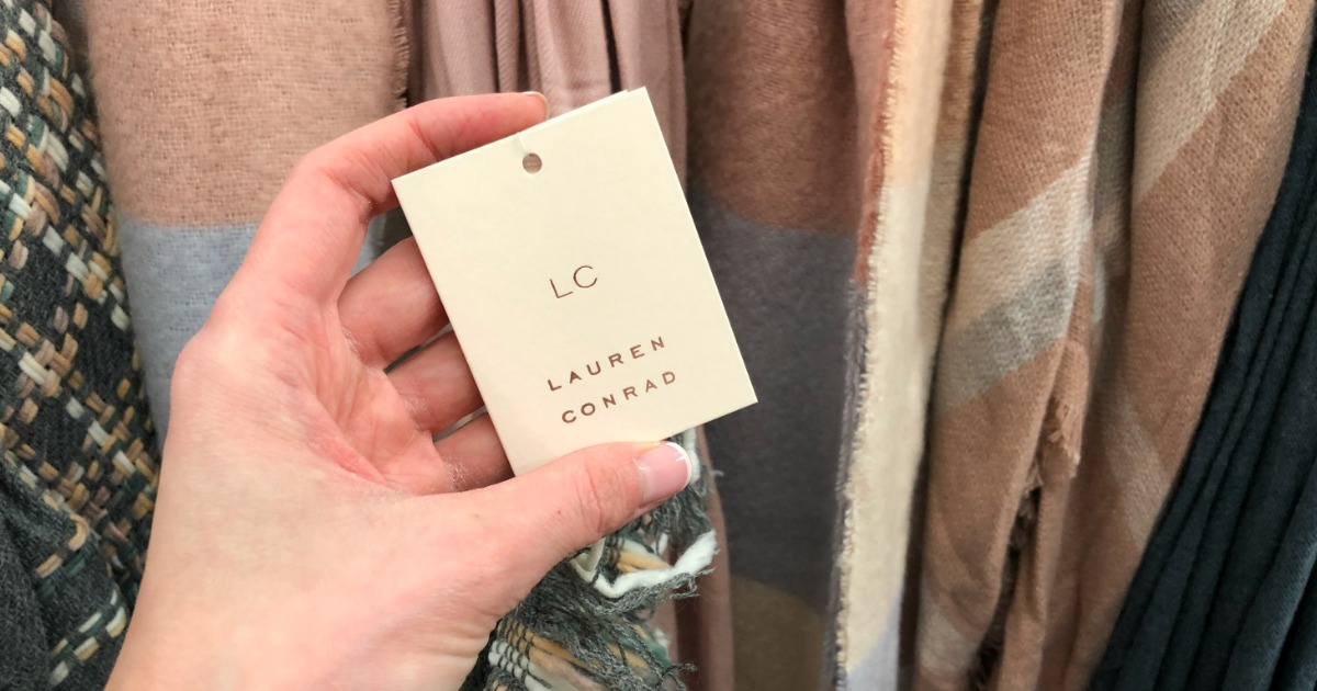 hand holding Lauren Conrad tag on a scarf
