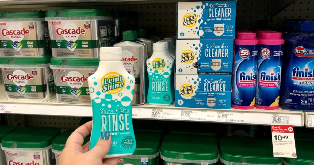Woman holding Lemi Shine Rinse next to Dishwasher Cleaner in Target