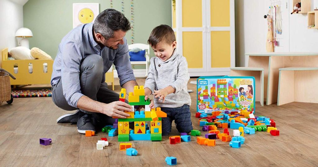 male and boy playing with Mega Bloks Building Basics on hardwood floor