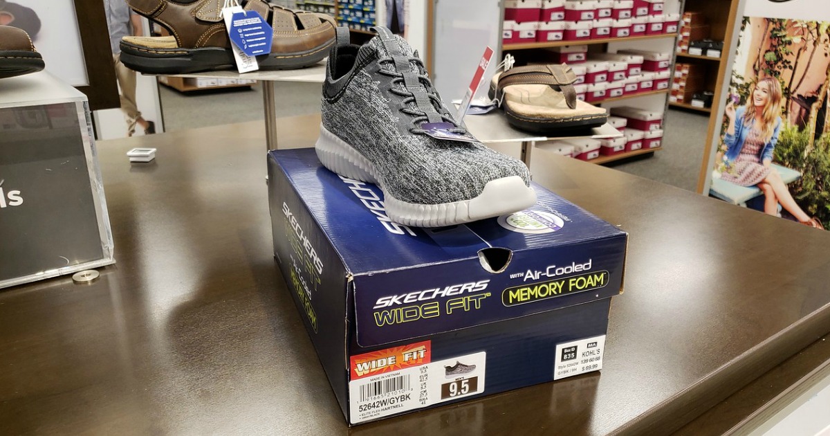 gray patterend skechers shoe on top of box on shelf at store