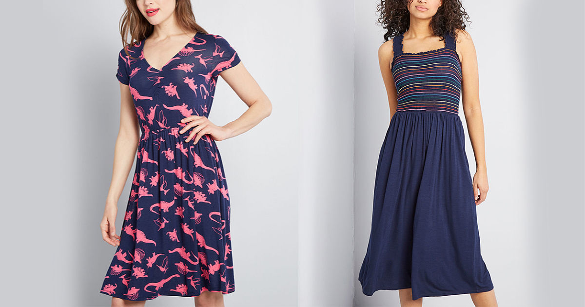 woman wearing a dinosaur print dress and woman wearing a navy and rainbow dress