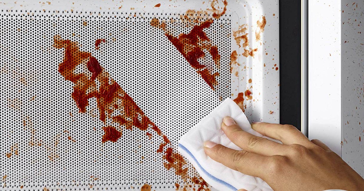 Mr. Clean Magic Eraser removing baked on food inside microwave