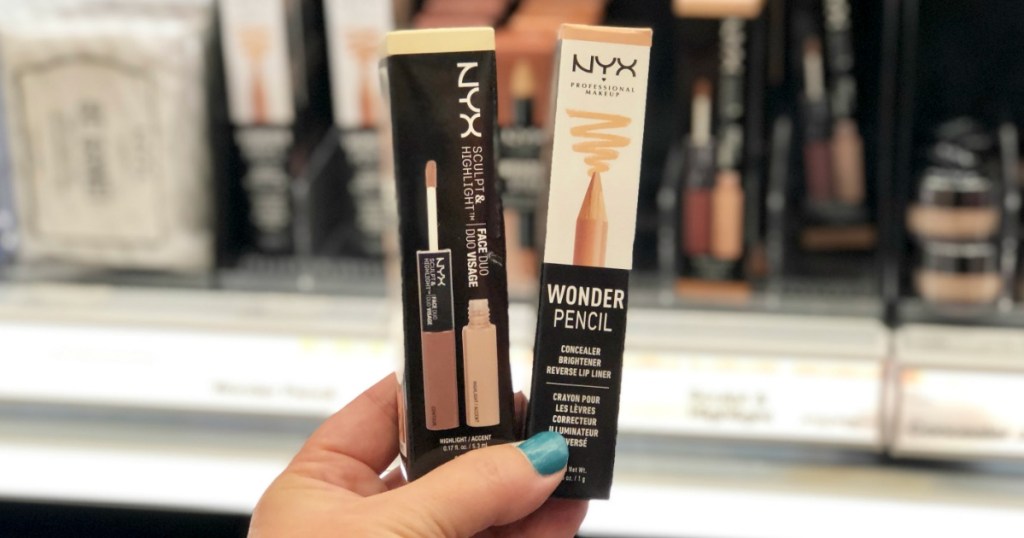 Woman with blue thumbnail holding NYX Professional Wonder Pencil and Sculpt & Highlight Duo
