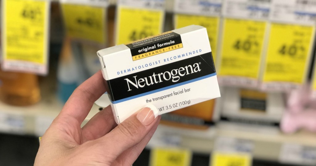 hand holding Neutrogena facial bar with blurred background