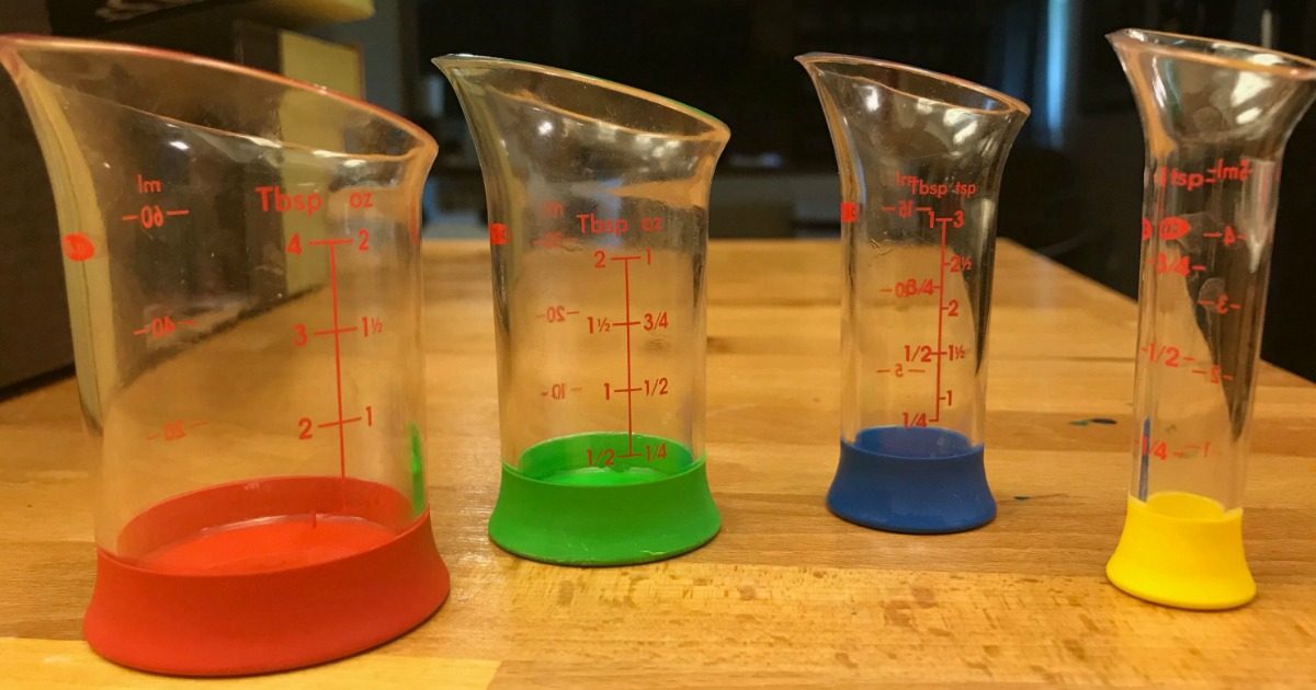 four liquid measuring beakers sitting on table