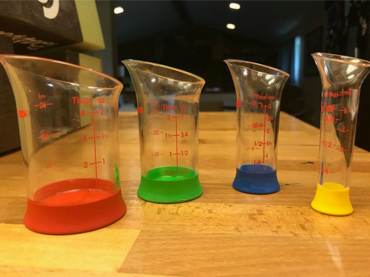 four liquid measuring beakers sitting on table