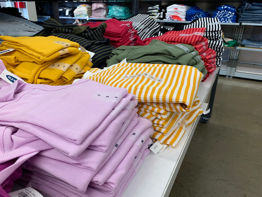 Old Navy Women's Tanks folded on a table at the store