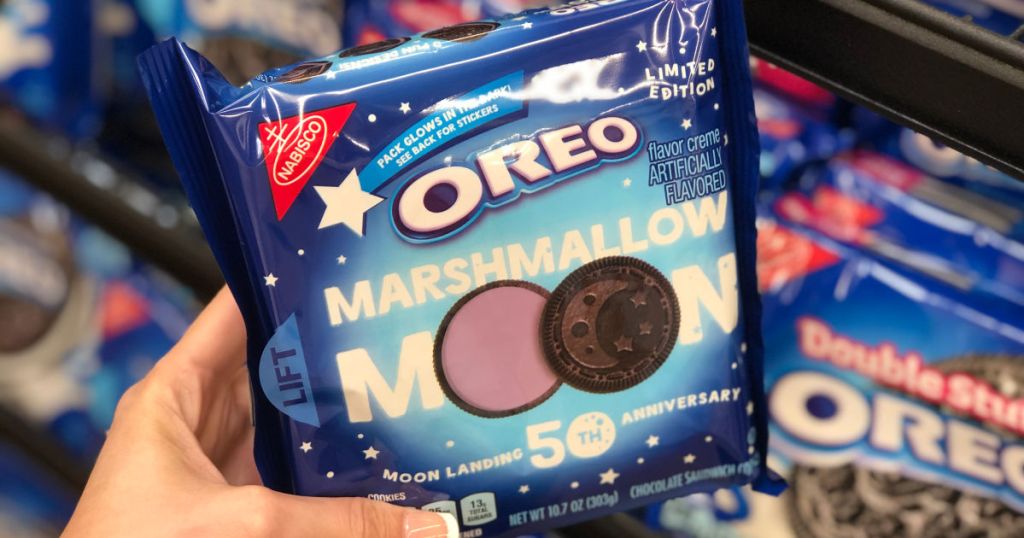 woman hand holding oreo marshmallow moon 50th anniversary pack in front of oreo display