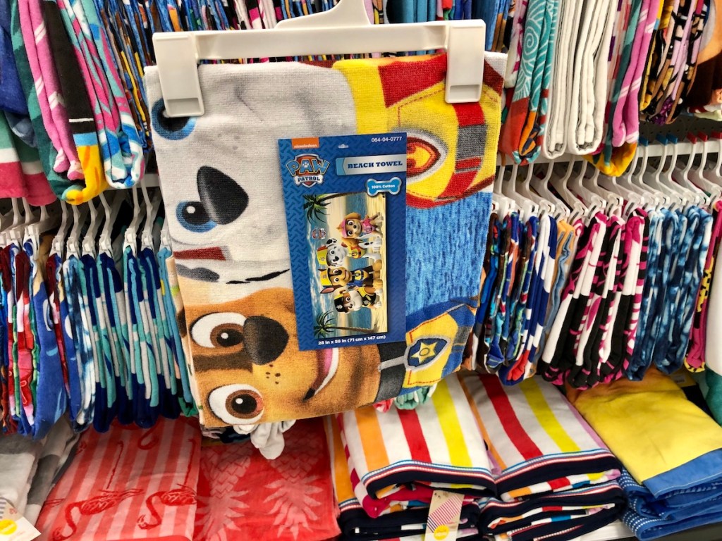 Paw Patrol beach towel on hanger in front of other towels