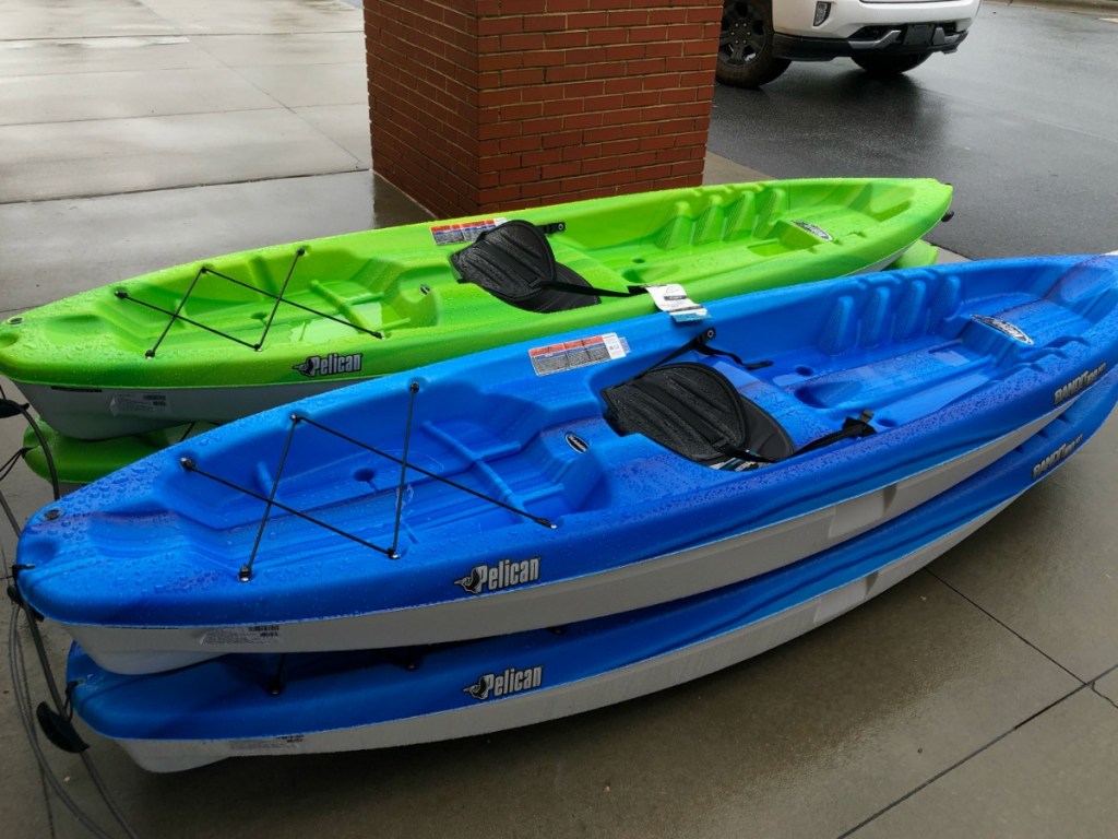 Neon green and blue kayak on a sidewalk