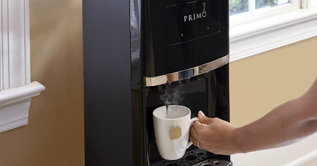 hand getting hot water dispensed into coffee cup from primo dispenser